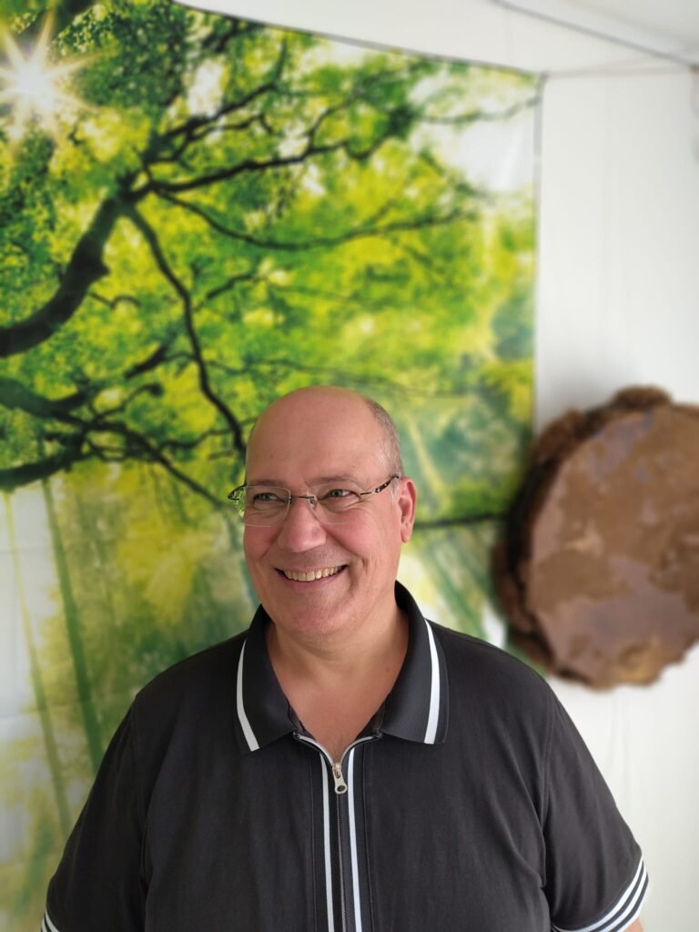 Frank van Being in Harmony, glimlachend in zijn praktijkruimte